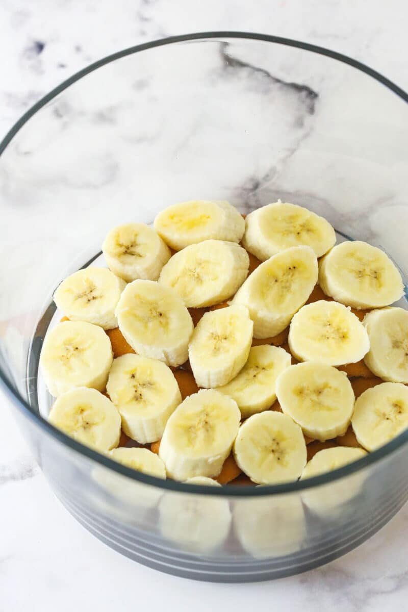 This copycat Magnolia Bakery Banana Pudding is made completely from scratch and mirrors the texture and flavors of the original. Bananas layered on top of Nilla wafers in a glass bowl