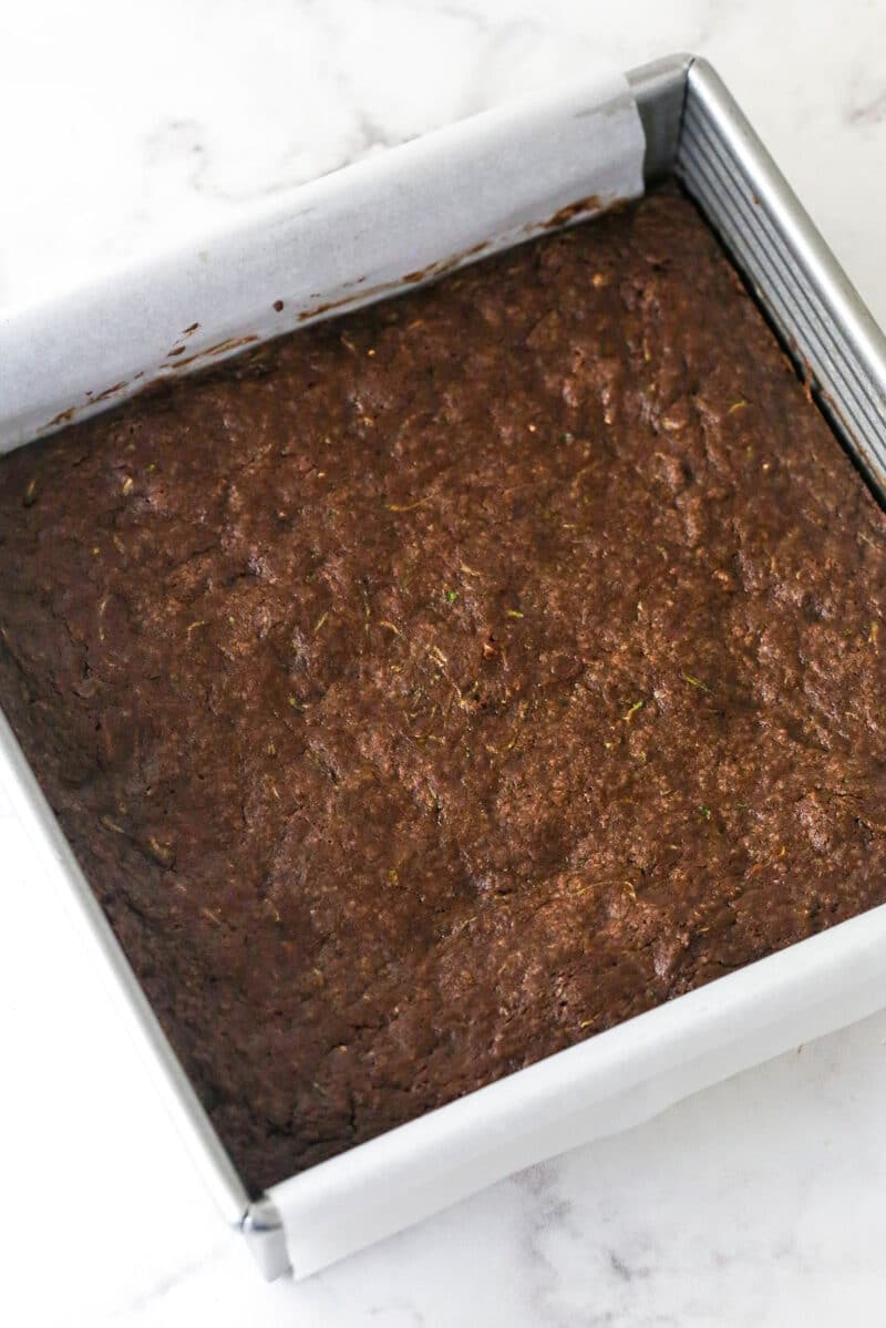 These zucchini brownies are not only quick and easy to make, they have the perfect super dense and fudgy texture. Overhead view of a pan of zucchini brownies