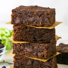 Four zucchini brownies stacked on each other