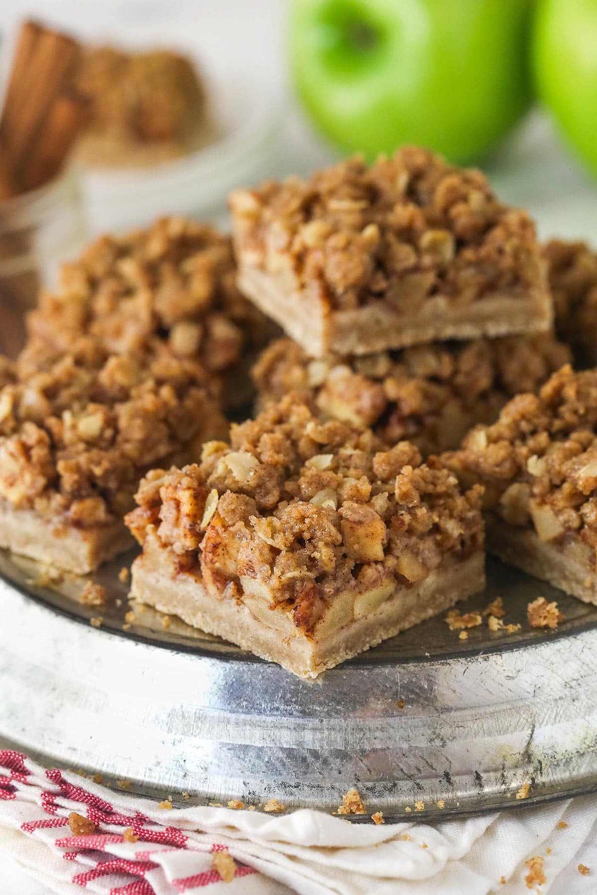 Apple pie bars offer all of the flavor of apple pie in a simple, easy-to-make bar, with shortbread crust, spiced apples, and crumble topping. A plate of apple pie bars