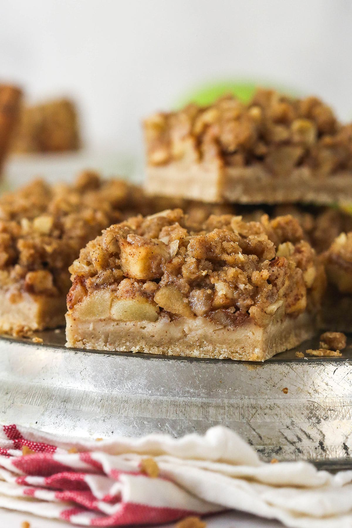 Apple pie bars offer all of the flavor of apple pie in a simple, easy-to-make bar, with shortbread crust, spiced apples, and crumble topping. Side view of a plate of apple pie bars