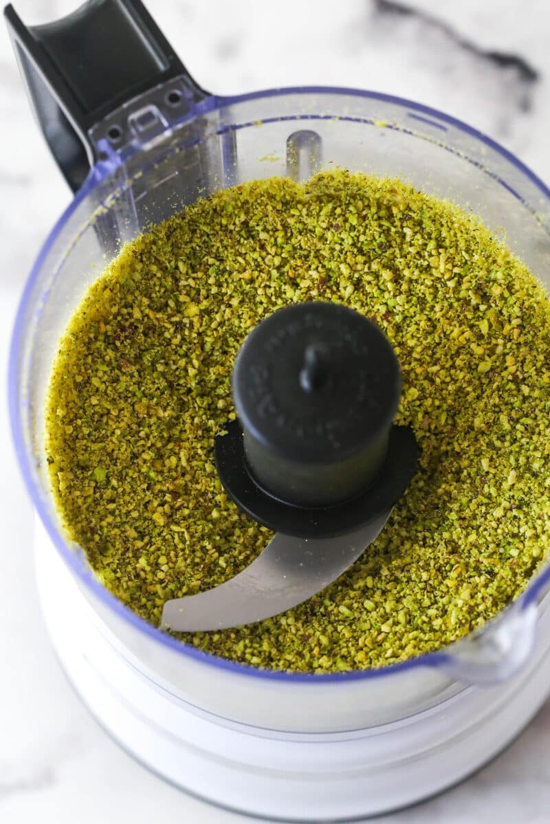 These pistachio cupcakes are full of real pistachios in the cupcakes and the buttercream, giving them their beautiful color and nutty flavor. Pistachio crumbs in a food processor