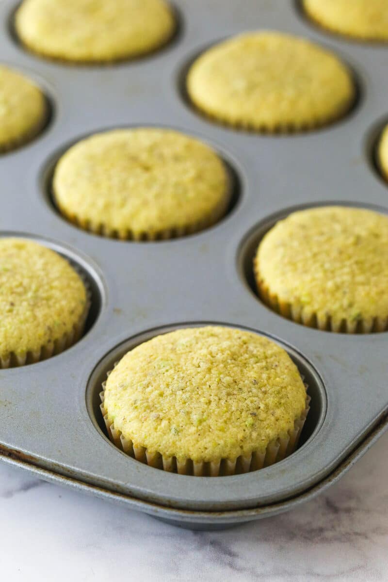 These pistachio cupcakes are full of real pistachios in the cupcakes and the buttercream, giving them their beautiful color and nutty flavor. Baked pistachio cupcakes in a muffin tin