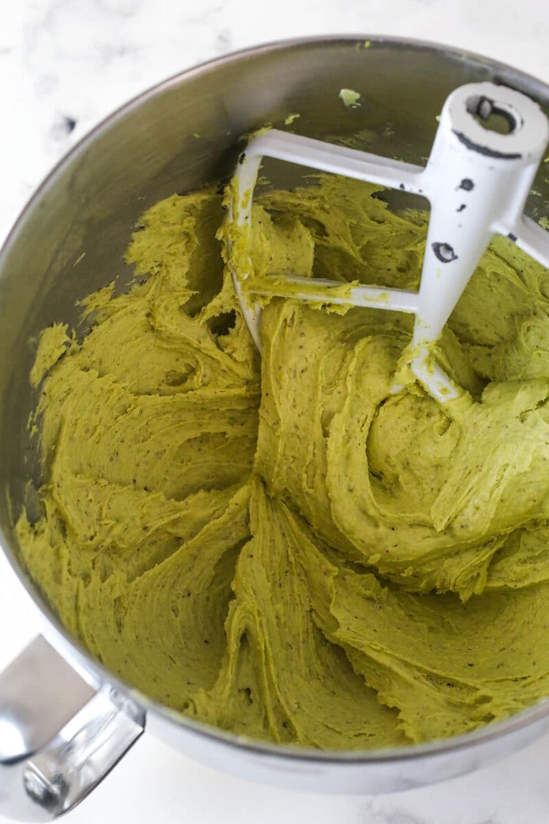 These pistachio cupcakes are full of real pistachios in the cupcakes and the buttercream, giving them their beautiful color and nutty flavor. Pistachio buttercream in a mixing bowl