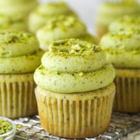 Front view of pistachio cupcakes on a wire cooling rack
