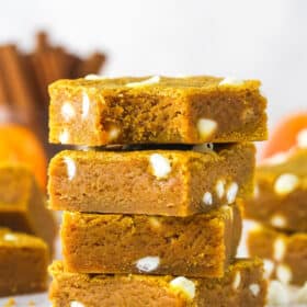 A stack of four pumpkin blondies, the top one missing a bite