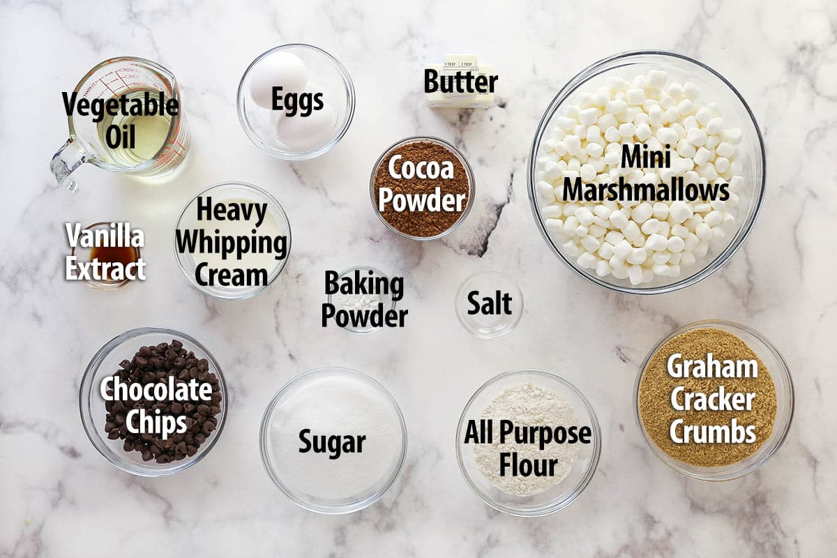 These s'mores brownies have all the classic flavors, with a graham cracker crust, fudgy brownies, ganache, and toasted marshmallows. Overhead view of ingredients needed to make s'mores brownies