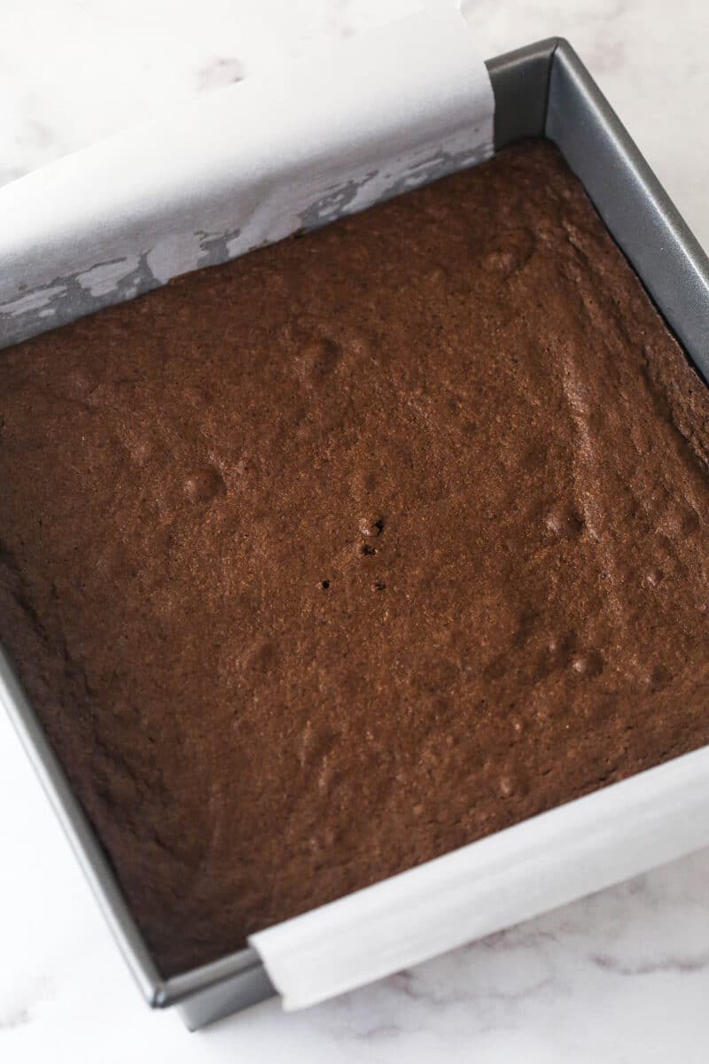 These s'mores brownies have all the classic flavors, with a graham cracker crust, fudgy brownies, ganache, and toasted marshmallows. Baked brownies in a square pan