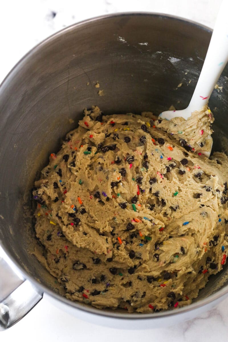 Brownie cookie dough ice cream sandwiches combine three favorites in one, with a few key ingredients to ensure they stay soft. Folding sprinkles and mini chocolate chips into cookie dough