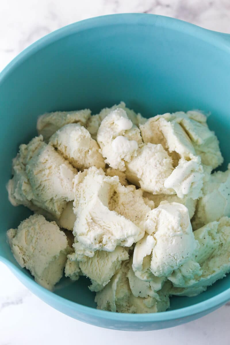 Brownie cookie dough ice cream sandwiches combine three favorites in one, with a few key ingredients to ensure they stay soft. Softened vanilla ice cream in a bowl