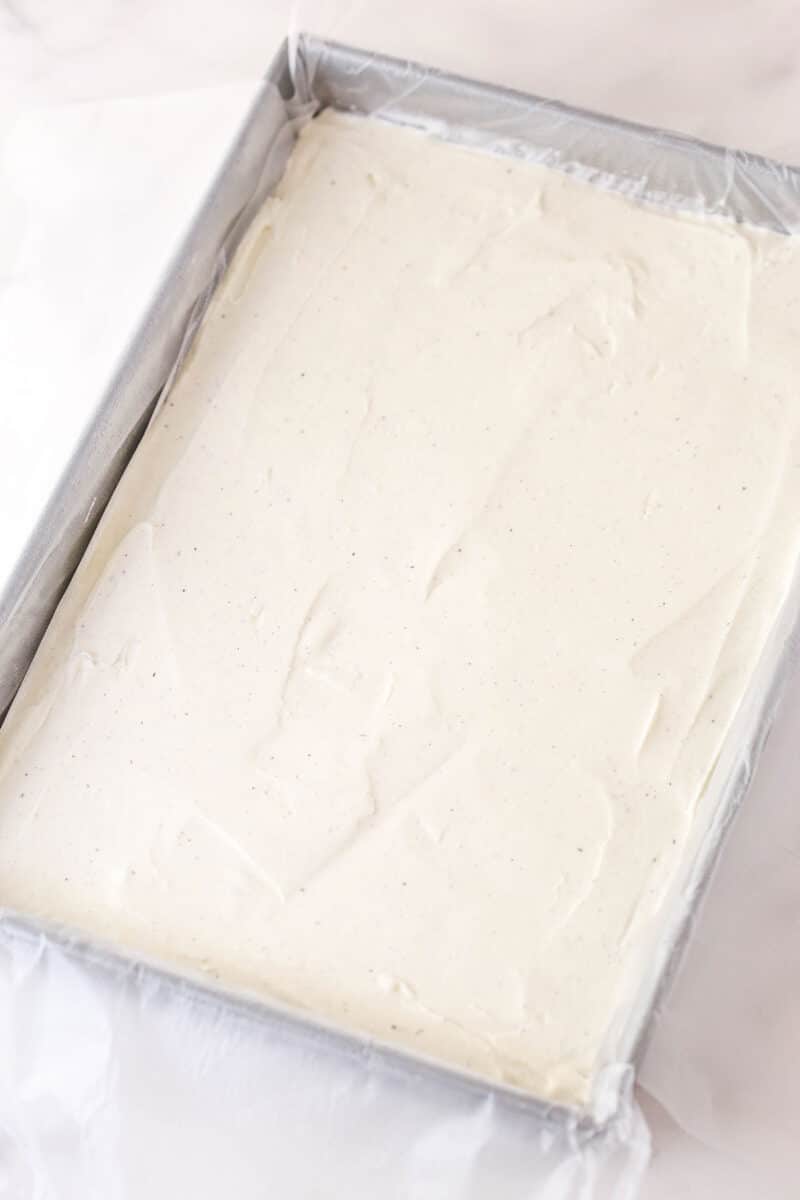 Brownie cookie dough ice cream sandwiches combine three favorites in one, with a few key ingredients to ensure they stay soft. Vanilla ice cream spread in the bottom of a pan