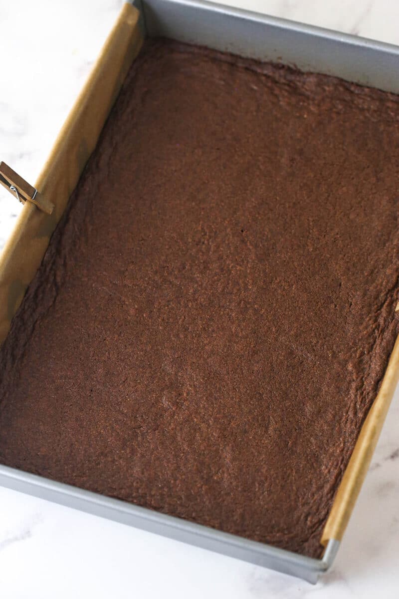 Brownie cookie dough ice cream sandwiches combine three favorites in one, with a few key ingredients to ensure they stay soft. Baked brownies in a pan