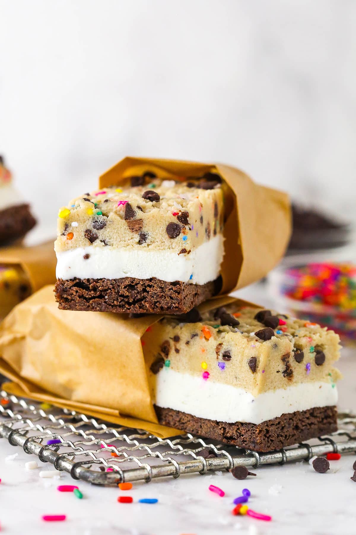 Brownie cookie dough ice cream sandwiches combine three favorites in one, with a few key ingredients to ensure they stay soft. Brownie cookie dough ice cream sandwiches on a plate