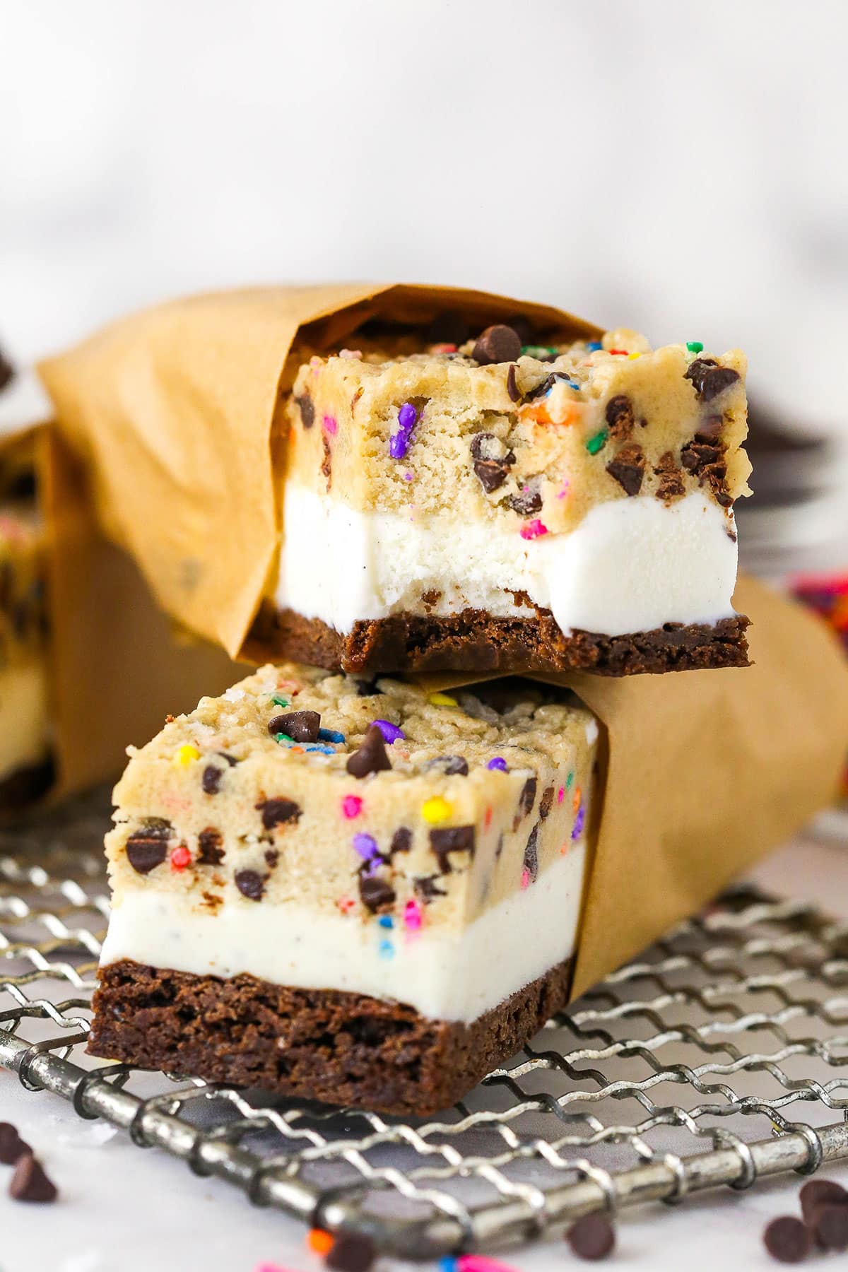 Brownie cookie dough ice cream sandwiches combine three favorites in one, with a few key ingredients to ensure they stay soft. Two brownie cookie dough ice cream sandwiches stacked on each other