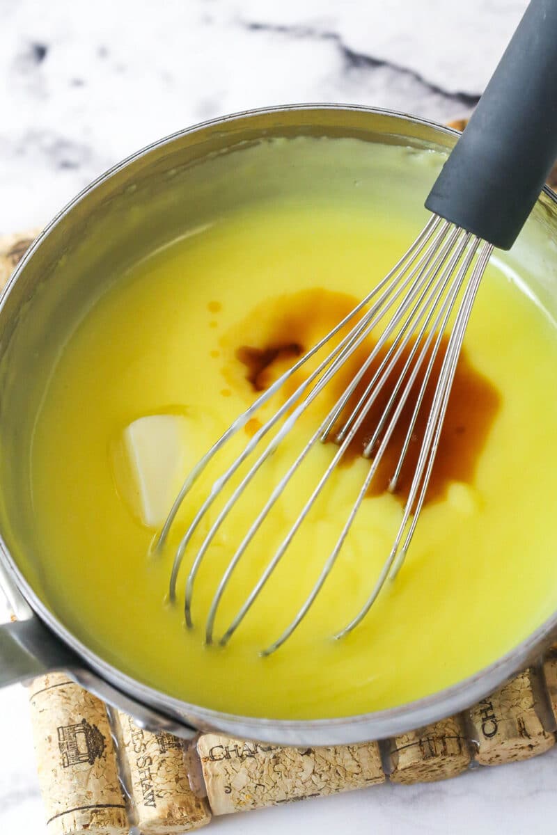 Master making cream puffs fit for a bakery and perfect for sharing with my in-depth tips and step-by-step photos. Whisking butter and vanilla into pastry cream