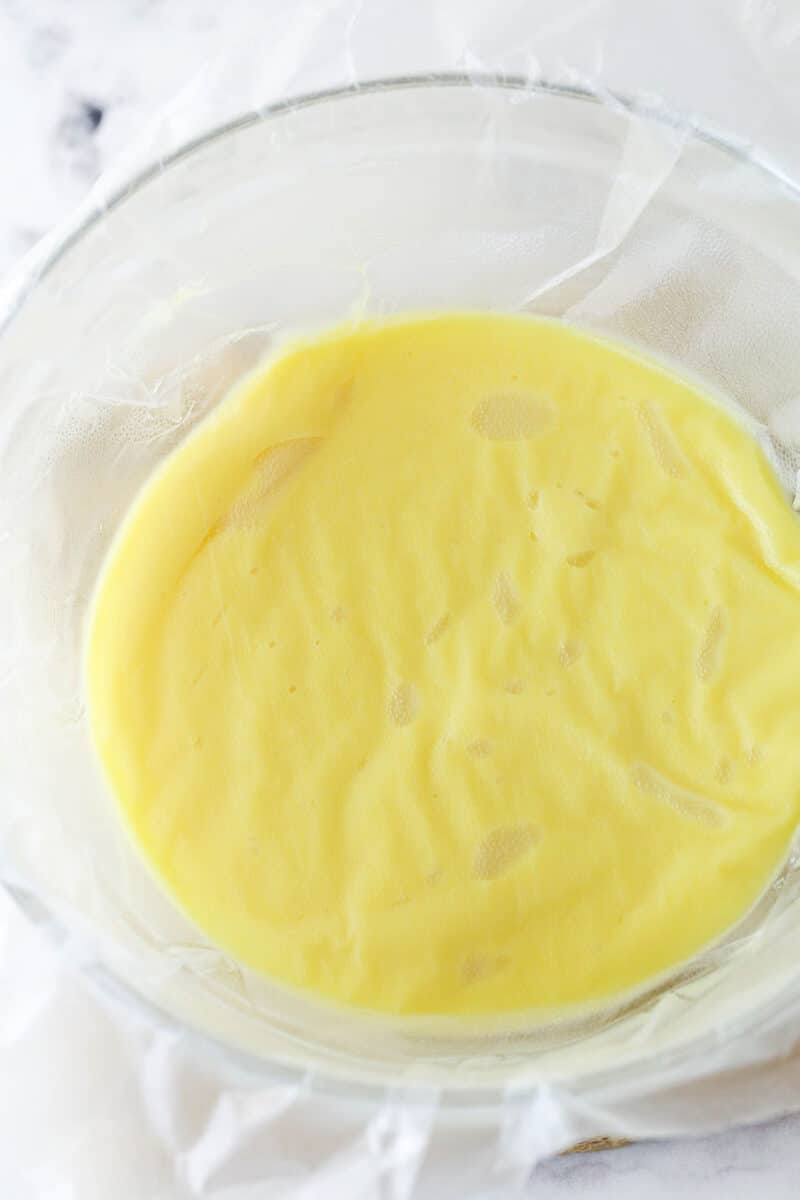 Master making cream puffs fit for a bakery and perfect for sharing with my in-depth tips and step-by-step photos. Pastry cream cooling in a bowl