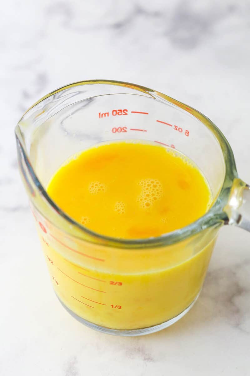 Master making cream puffs fit for a bakery and perfect for sharing with my in-depth tips and step-by-step photos. Whisked egg yolks in a measuring cup