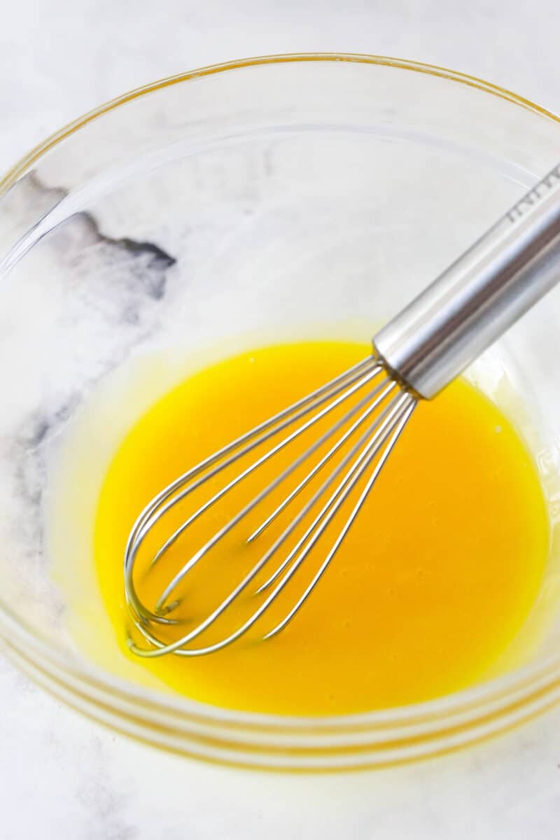 Mastering eclairs at home is easier than you think with my step-by-step photos and in-depth tips. Made with pastry cream & chocolate glaze. Eggs whisked in a bowl