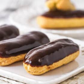 Chocolate eclairs on a white plate