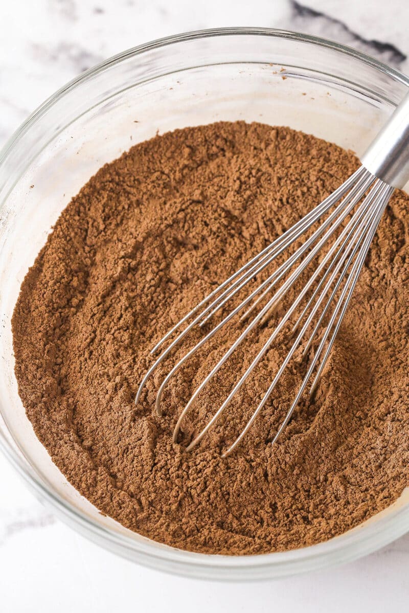 Creamy peanut butter is swirled into rich, chewy chocolate brownies in this easy Peanut Butter Brownies recipe. Whisking dry brownie ingredients in a bowl