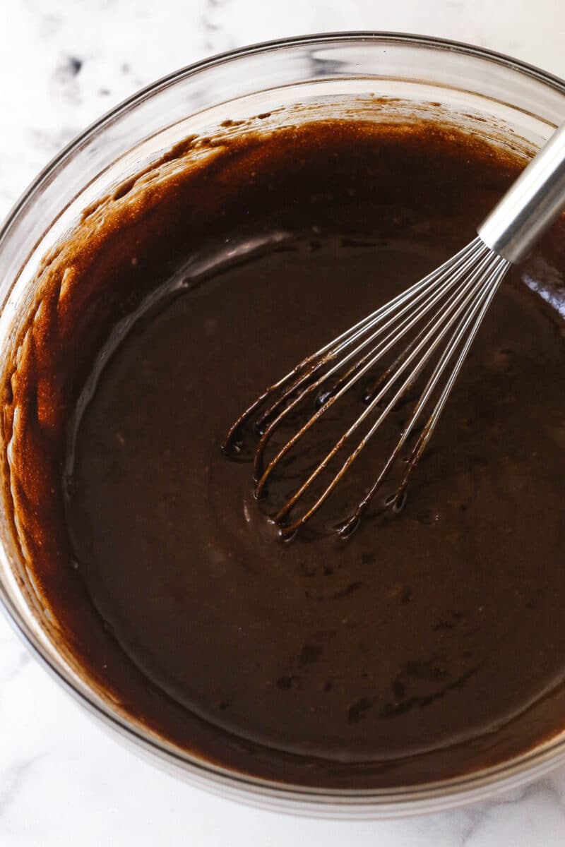 Creamy peanut butter is swirled into rich, chewy chocolate brownies in this easy Peanut Butter Brownies recipe. Whisking brownie batter in a bowl