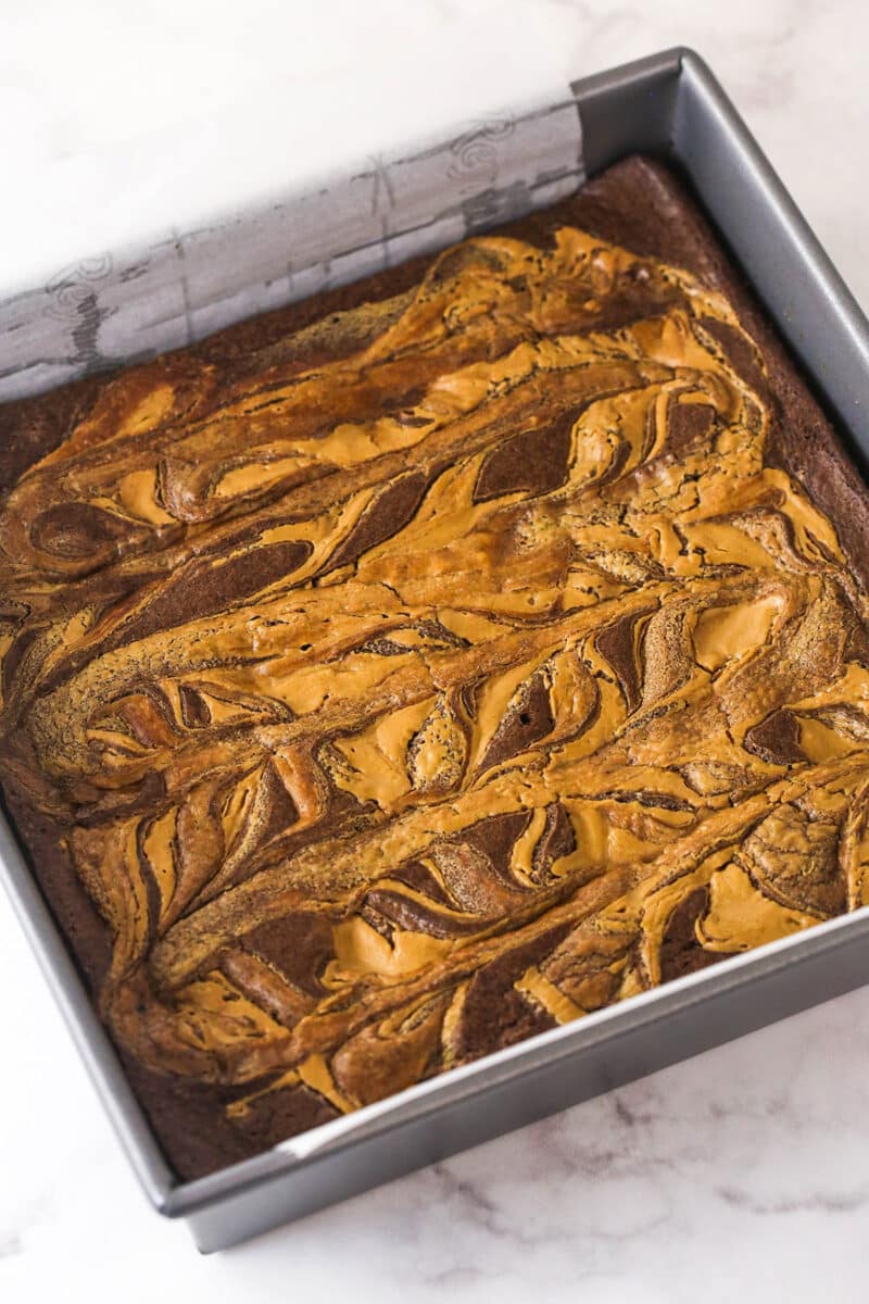 Creamy peanut butter is swirled into rich, chewy chocolate brownies in this easy Peanut Butter Brownies recipe. Overhead view of a pan of baked peanut butter brownies