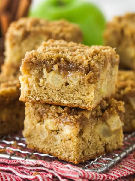 Apple streusel bars stacked on a wire rack