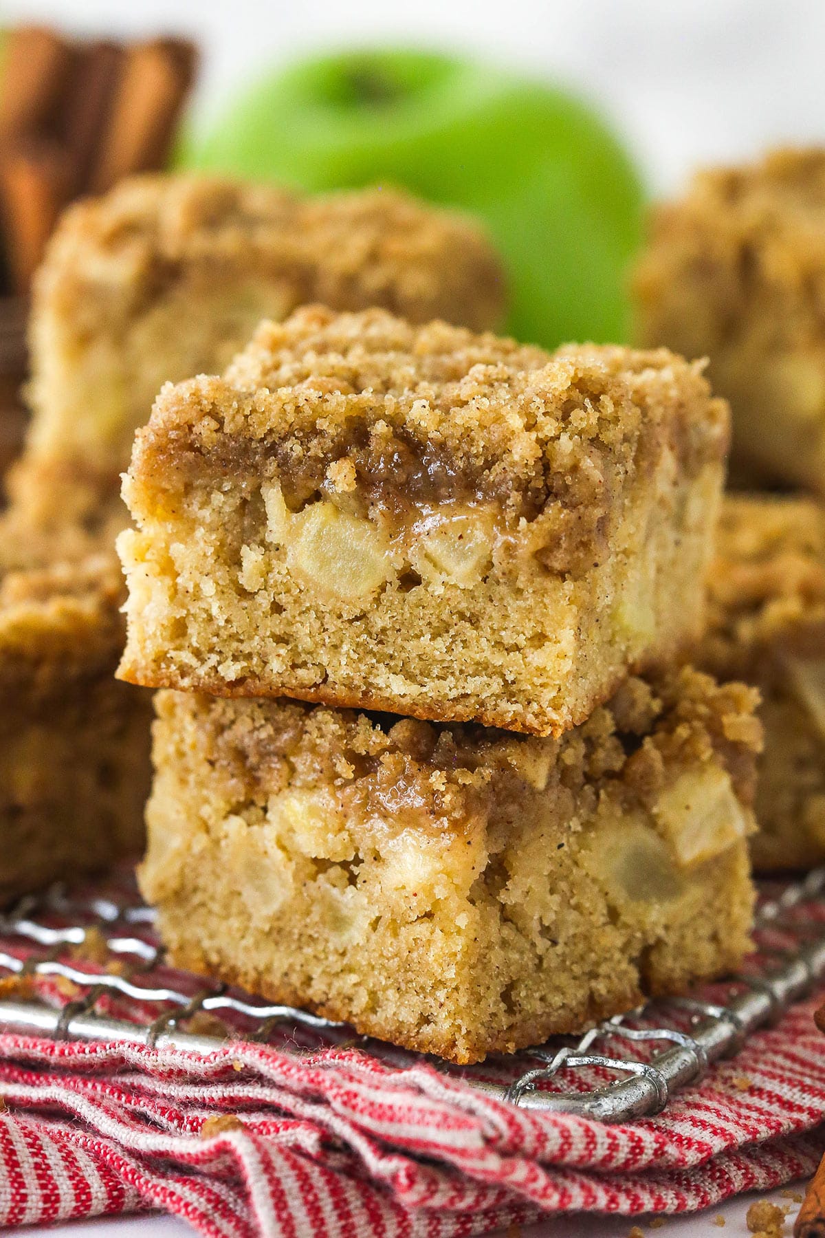 Apple streusel bars stacked on a wire rack