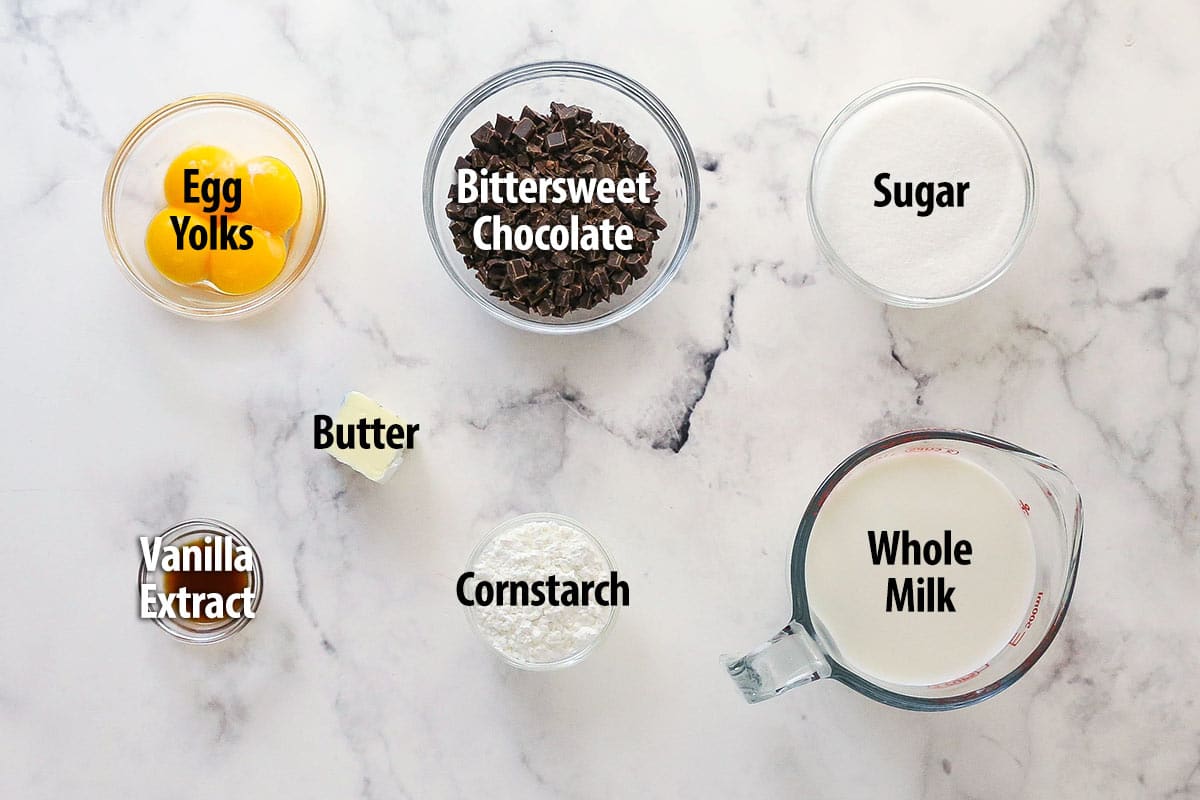 Thick, smooth, and creamy, this chocolate pastry cream (aka chocolate crème pâtissière) can be used in cakes, pastries, and other desserts. Overhead view of ingredients needed to make chocolate pastry cream