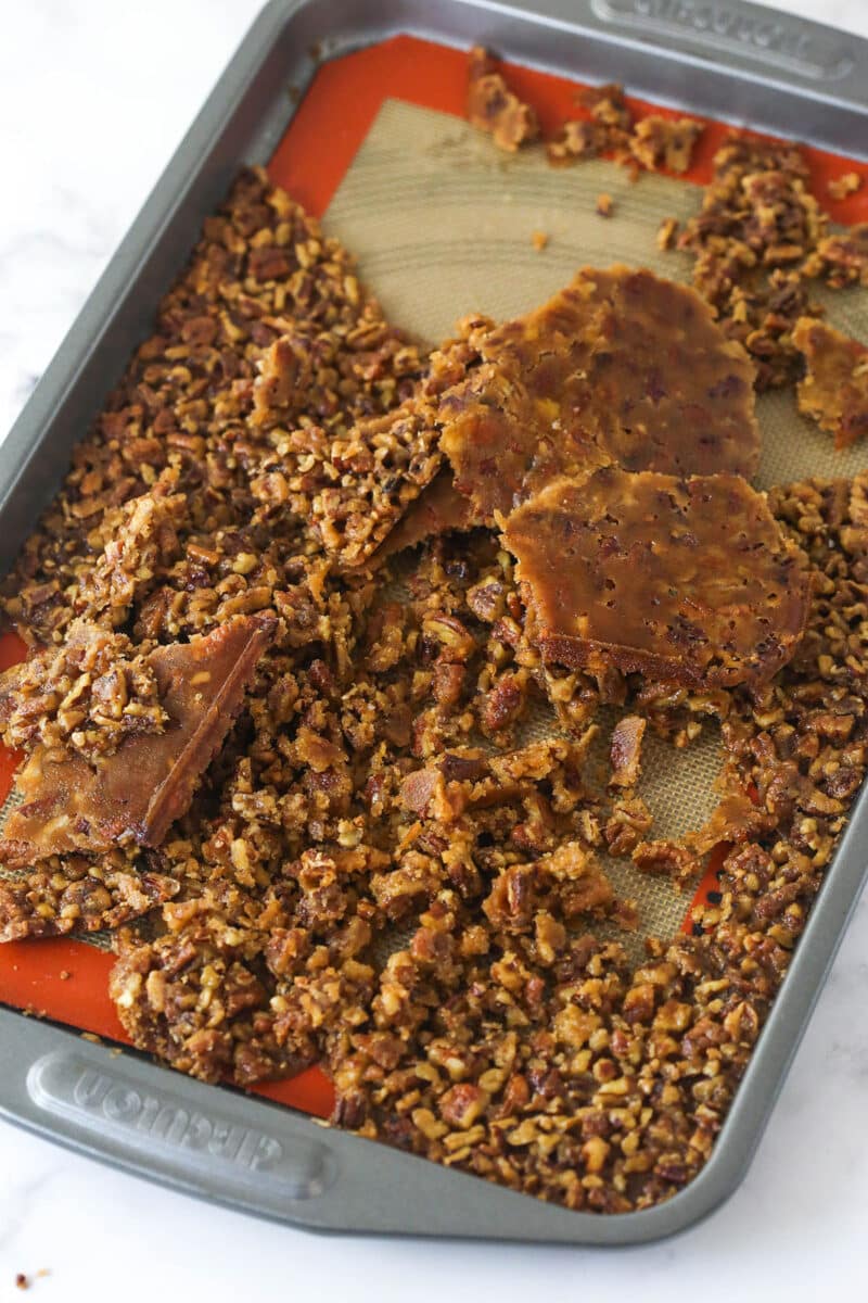 With layers of pumpkin cake, pecan praline crunch, and a caramel buttercream, this pecan praline pumpkin cake is impressive and delicious. Pecan praline crunch in a baking sheet some broken into pieces