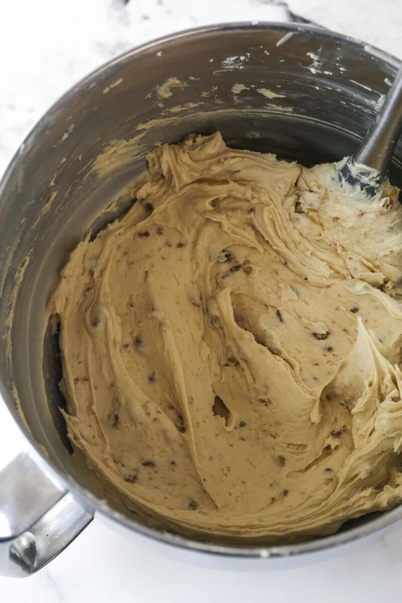 With layers of pumpkin cake, pecan praline crunch, and a caramel buttercream, this pecan praline pumpkin cake is impressive and delicious. Caramel buttercream in a mixing bowl