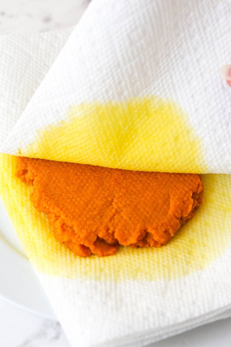 pumpkin puree on paper towels being blotted to remove moisture