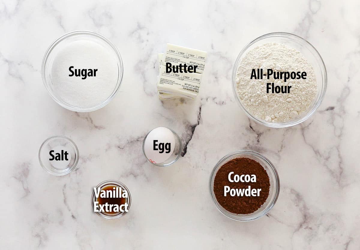chocolate spritz cookie ingredients on marble background