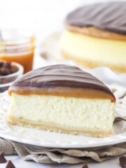 A slice of millionaire cheesecake on a plate.