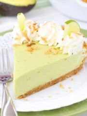 Close up of a slice of avocado key lime pie on a small white plate.
