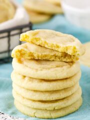 Six Sugar Cookies stacked with the top Sugar Cookie broken in half