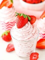 Homemade Strawberry Whipped Cream piped into a clear glass